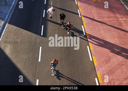 All good things are wild and free. a group of skaters skating in the city. Stock Photo