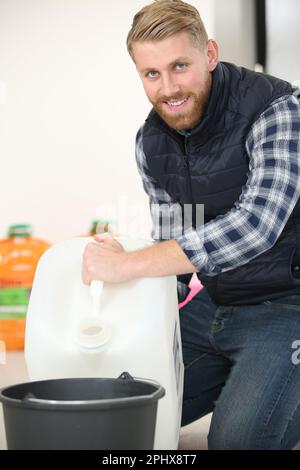 man holding a bottle of water Stock Photo