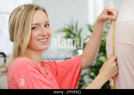 young tailor doing some measurement Stock Photo