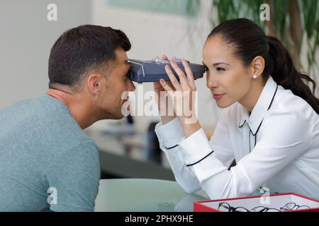 woman doing eye test with optometrist in eye sight clinic Stock Photo