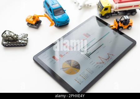 Tablet computer with different types of toy transport Stock Photo