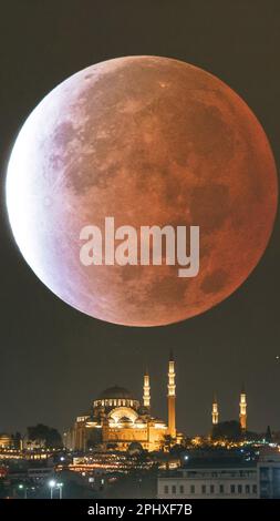 Kadir Gecesi or Laylat al-qadr concept vertical photo. Suleymaniye Mosque with lunar eclipse. Ramadan or islamic background photo. Stock Photo
