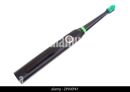 Close-up of a black and green electric toothbrush isolated on white background. Stock Photo