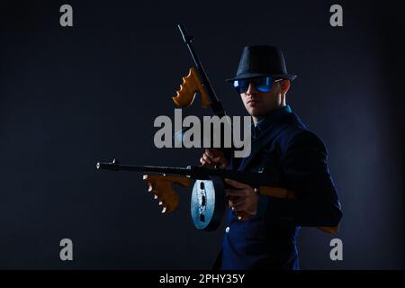low key portrait of young gangster with hat in the darkness Stock Photo