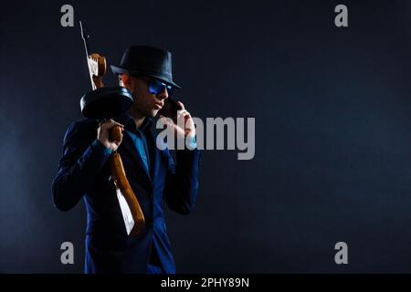 low key portrait of young gangster with hat in the darkness Stock Photo
