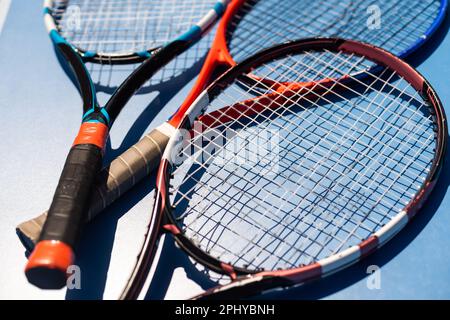 broken tennis rackets on clay tennis court Stock Photo