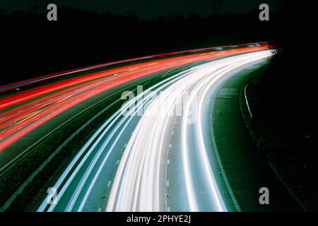 Light trails from moving traffic on the M60 motorway, Greater Manchester, England, UK. Theme or concept of travel, motion, speed, urban, commuting Stock Photo
