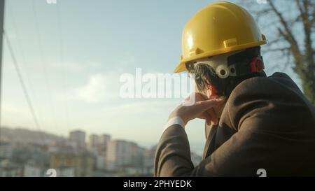 Thoughtful Young Construction Engineer or Contractor Wearing Beret Contemplates City Planning Stock Photo