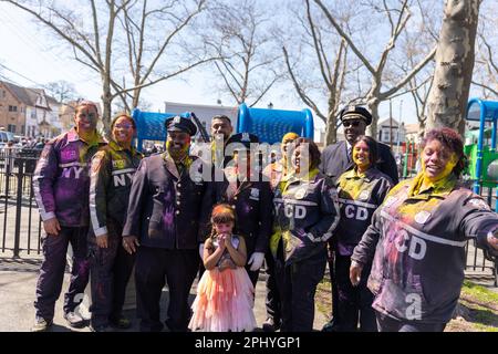 A diverse group of NYCD standing in a row, smiling and looking at the cameraat the Phagwah Holi Parade 2023 in Queens, NY Stock Photo