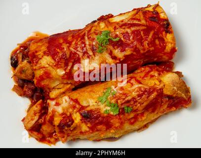 chicken and blackbean enchiladas, close up on plate Stock Photo