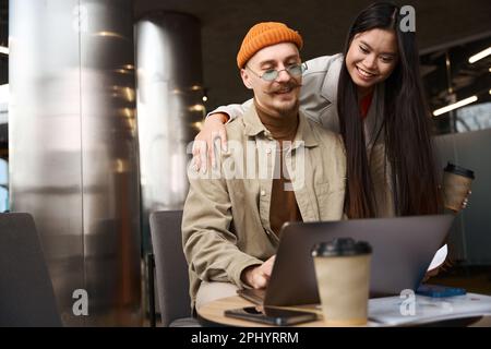 Cheerful young corporate workers involved in work Stock Photo