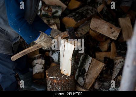 Grandfather chopping firewood Stock Photo