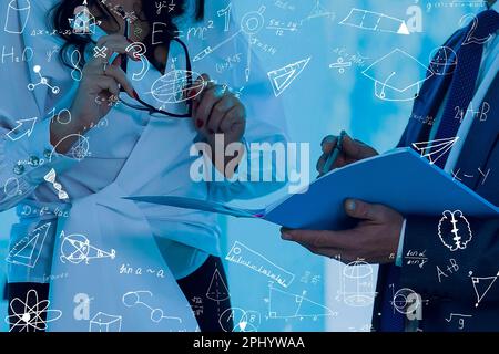 science, research and chemistry concept - young scientist in safety glasses with test tube and virtual projection of chemical formula. Stock Photo