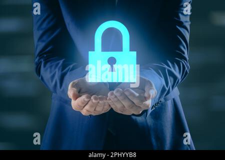 Cyber security concept. Man holding virtual icon of padlock on dark background, closeup Stock Photo