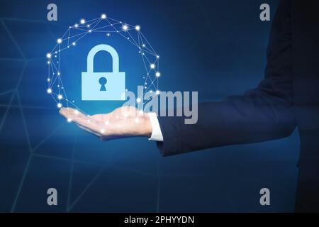 Cyber security concept. Man holding virtual icon of padlock on dark background, closeup Stock Photo