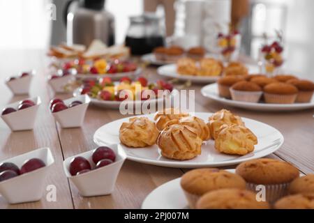 Table with different delicious snacks indoors. Coffee break Stock Photo