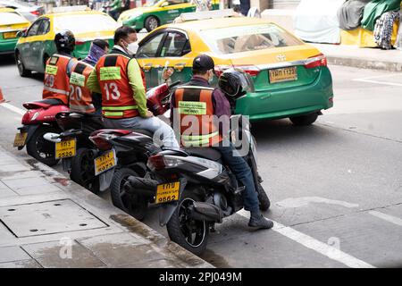 Motorcycle taxis wait for customers in Sukhumvit, Bangkok, Thailand. Stock Photo