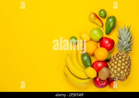 Healthy fruits food on yellow background. Flat lay with copy space Stock Photo