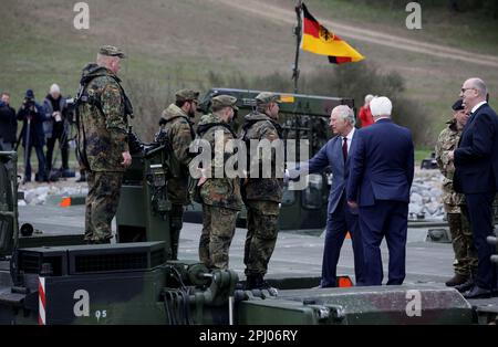 Finowfurt, Germany. 30th Mar, 2023. Brandenburg's Prime Minister Dietmar Woidke (r) observes the British King Charles III (3rd from right) and German President Frank-Walter Steinmeier (2nd from right) talking to soldiers during their visit to the 130th Anglo-German Engineer Bridge Battalion in Finowfurt. Before his coronation in May 2023, the British King and Queen will visit Germany for three days. Credit: Jens Schlueter/POOL/AFP/dpa/Alamy Live News Stock Photo