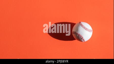 Baseball ball on orange background. Horizontal sport theme poster, greeting cards, headers, website and app Stock Photo