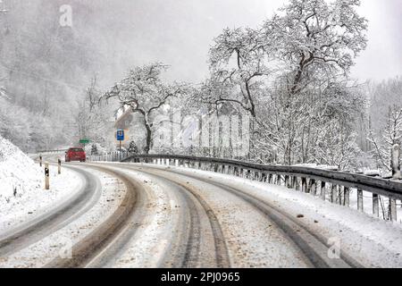 Winter onset, wintry road conditions with snow-covered roads Bad Urach, Baden-Wuerttemberg, Germany Stock Photo