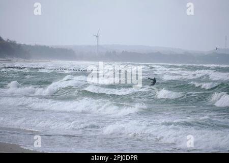 Kitesurfing in the sea during a storm and big waves Stock Photo