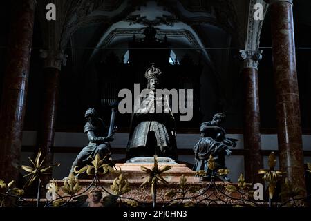 Kneeling Emperor Maximilian I flanked by bronze Cardinal Virtues on top of his cenotaph in the Hofkirche, Innsbruck, Austria Stock Photo
