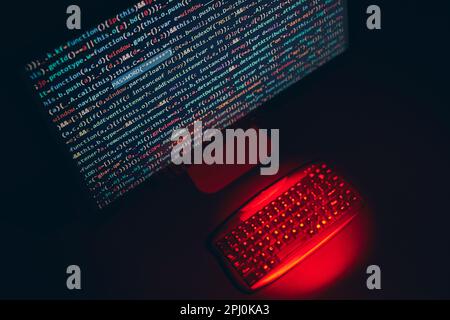 Cyber security. Program code on screen. Using computer and programming to break code. Cyber security threat. Internet and network security. Stealing p Stock Photo