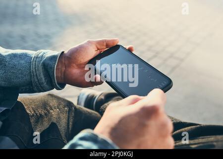 Person investing trading on stock cryptocurrency market using investing application on smartphone. Stock market investment in hand. Trader holding mob Stock Photo