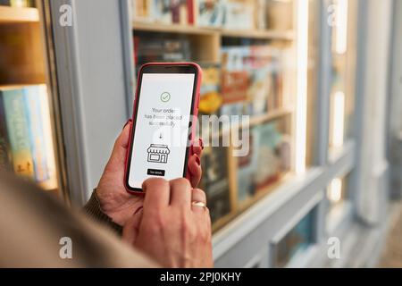 Online shopping. Buying product in online shop. Person paying using mobile payment app. Customer ordering item in e-shop on smartphone. E-commerce ove Stock Photo