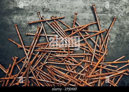 Rusty nails on steel surface. Tools for maintenance. Hardware tools to fix. Technical background with copy space Stock Photo
