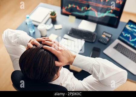 Worried businessman looking at charts stressed by news from stock market. Investor lost money online. Man analyses loss and profit. Businessman invest Stock Photo