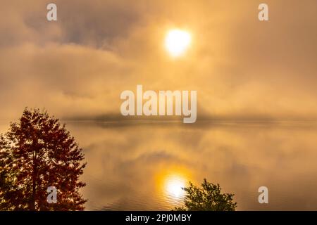 Cloudy Alpine Lake Lugano with Sunlight and Clouds on Surface Level in Lugano, Switzerland. Stock Photo