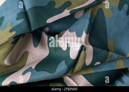 Cotton scarf - bandana with a beige - green camouflage pattern. Background close up Stock Photo