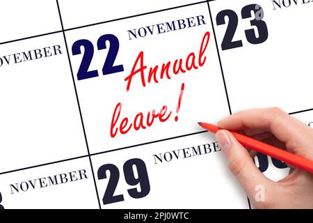 22nd day of November. Hand writing the text ANNUAL LEAVE and drawing the sun on the calendar date November 22. Save the date. Time for the holidays. v Stock Photo