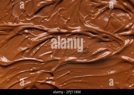 Chocolate background. Melted chocolate. Liquid milk chocolate. Handmade chocolate. Stock Photo