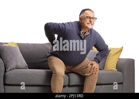 Mature man with back pain getting up from a sofa isolated on white background Stock Photo