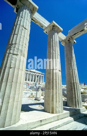 DORIC STONE COLUMNS PROPYLAEA COLONNADE AND PARTHENON ACROPOLIS RUINS ATHENS GREECE Stock Photo