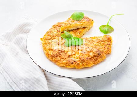 Spanish omelet (Tortilla de patatas) with potatoes and onion, typical Spanish cuisine. Stock Photo
