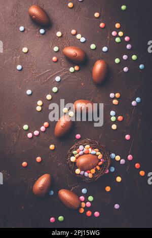 Sweet Easter - Chocolate eggs and colorful chocolate beans in bird nest Stock Photo