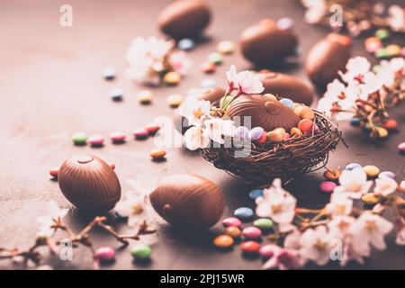 Sweet Easter - Chocolate eggs and colorful chocolate beans in bird nest Stock Photo