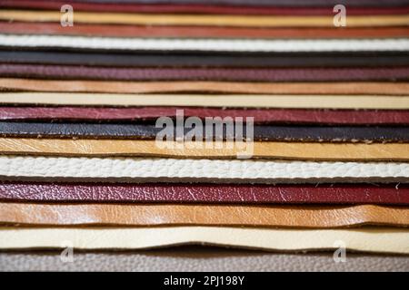 different colors pieces of leather as a background closeup Stock Photo