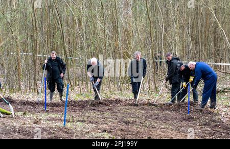 Police search woodland for the remains of  Jason Martin-Smith who was killed over  20 years agho in 2001 aged 28. His body has never been found although hus killer, Mark Searle, was jailed for 29 years for his murder.Battle, East sussex. Multiple police officers have been investigating in fields close to Marley Lane in Battle with a blue tent erected by the side of the site. 30th March 2023  The murder of the victim, which took place in 2001, has been solved, but police have been unable to find the whereabouts of the body. Stock Photo