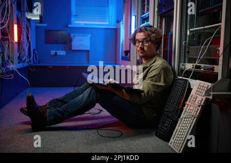 Data center engineer using keyboard on supercomputer server room Stock Photo