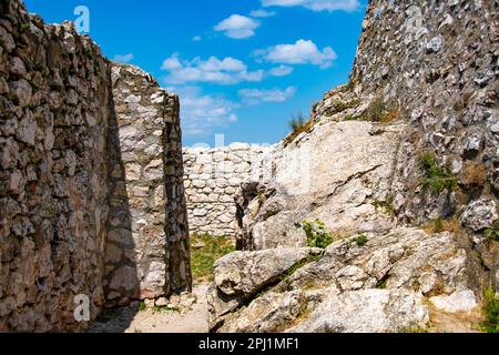 Rock and stone walls in front of blue sky Stock Photo