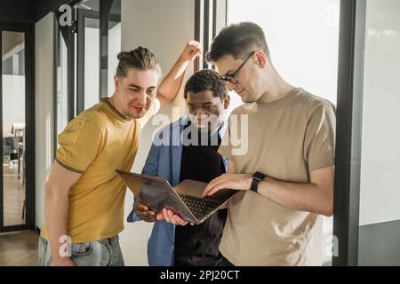 A young developer gives new project tasks to his partners. Business people are discussing a new business project in the office. Coding technologies Stock Photo