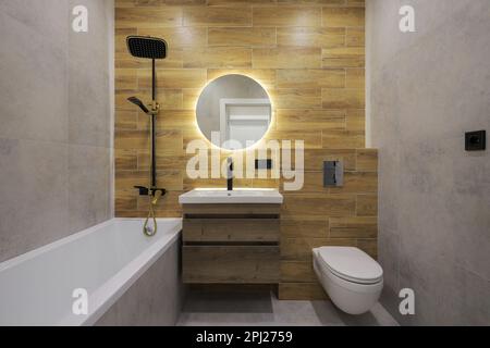 Bathtub and toilet in the bathroom interior Stock Photo