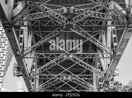 Underneath of large highway bridge. Under the bridge in downtown of Vancouver BC. Geometric shapes of bridge structure. View from the bottom, nobody, Stock Photo