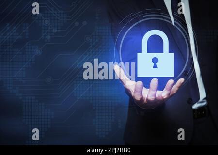 Cyber security concept. Man holding virtual icon of padlock on dark background, closeup Stock Photo