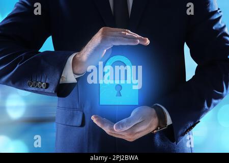 Cyber security concept. Man holding virtual icon of padlock on color background, closeup Stock Photo
